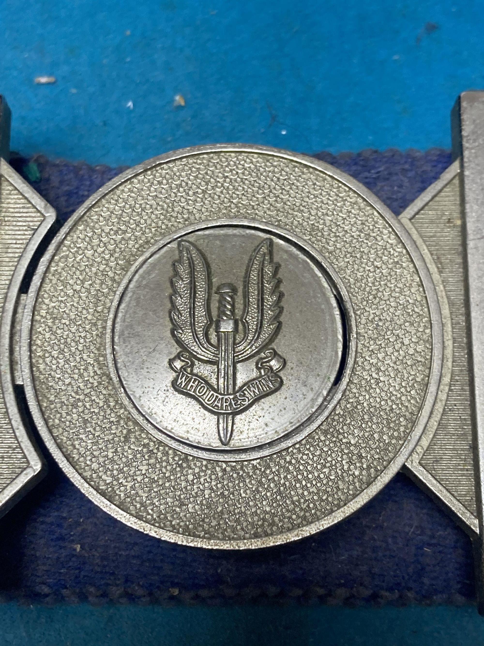 A group of Special Air Service SAS embroidered insignia, a belt and other military items, includes a Malayan Scouts insignia and a group of unnamed miniatures